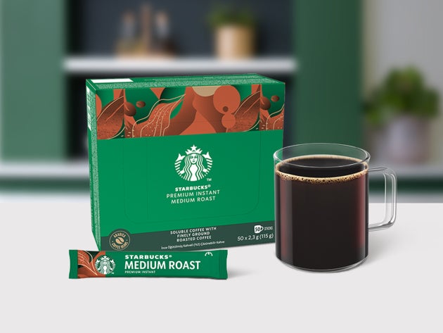 Cafea Starbucks® Premium Instant Medium Roast într-o cană de sticlă, expusă alături de un pliculeț și un ambalaj 