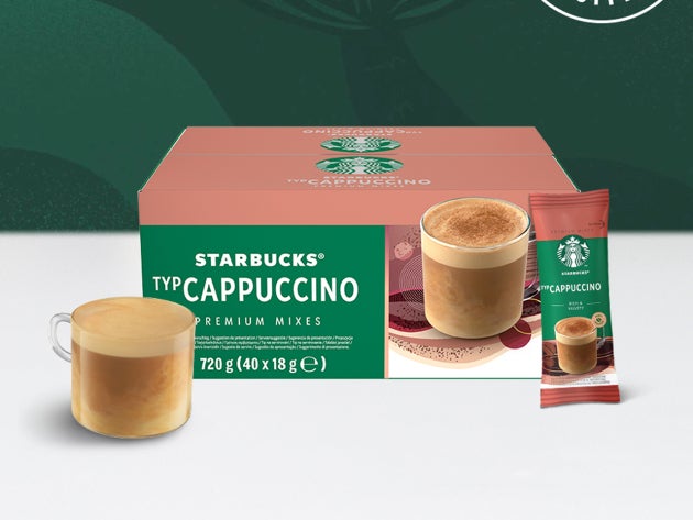 Cafea Starbucks® Cappuccino Premium Instant într-o cană de sticlă, expusă alături de un pliculeț și un ambalaj